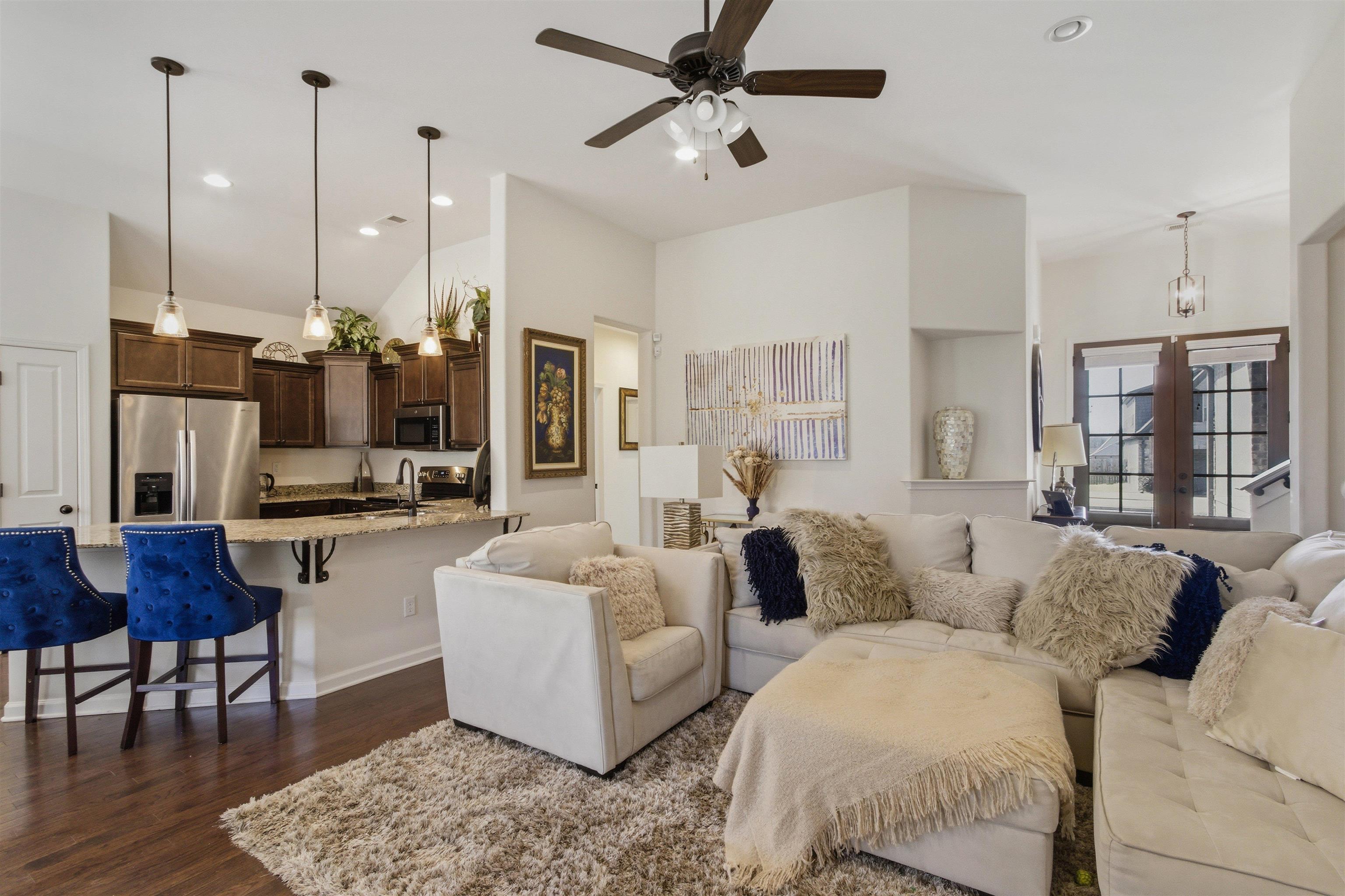 4996 Granite Creek Road Memphis, TN 38125 - Photo 8 of 37 a living room with furniture and a chandelier