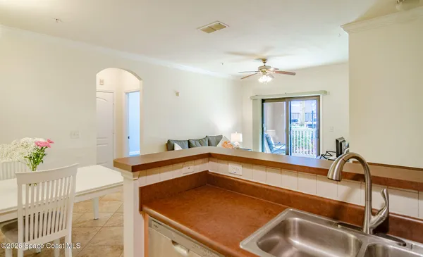 a front view of a house with a yard and fountain in middle