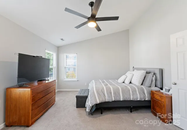 a bedroom with bed and a flat screen tv