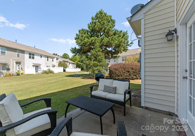 a balcony with table and chairs
