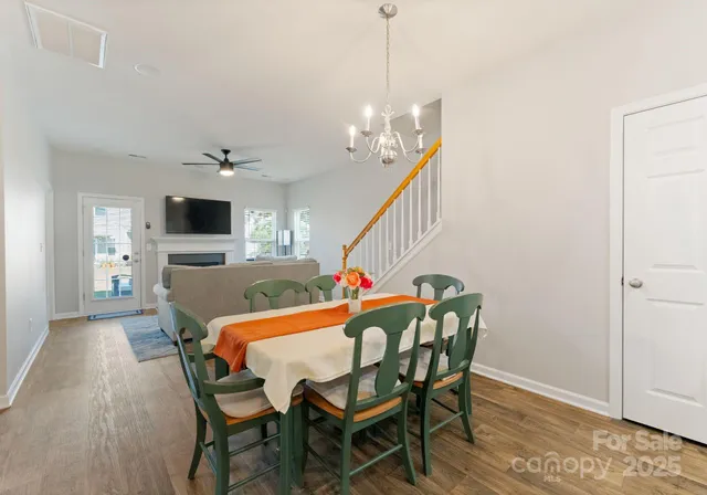 a view of a dining room with furniture and chandelier