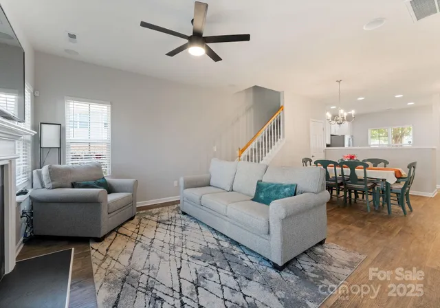 a living room with furniture and a chandelier