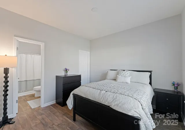 a bedroom with a bed and a potted plant