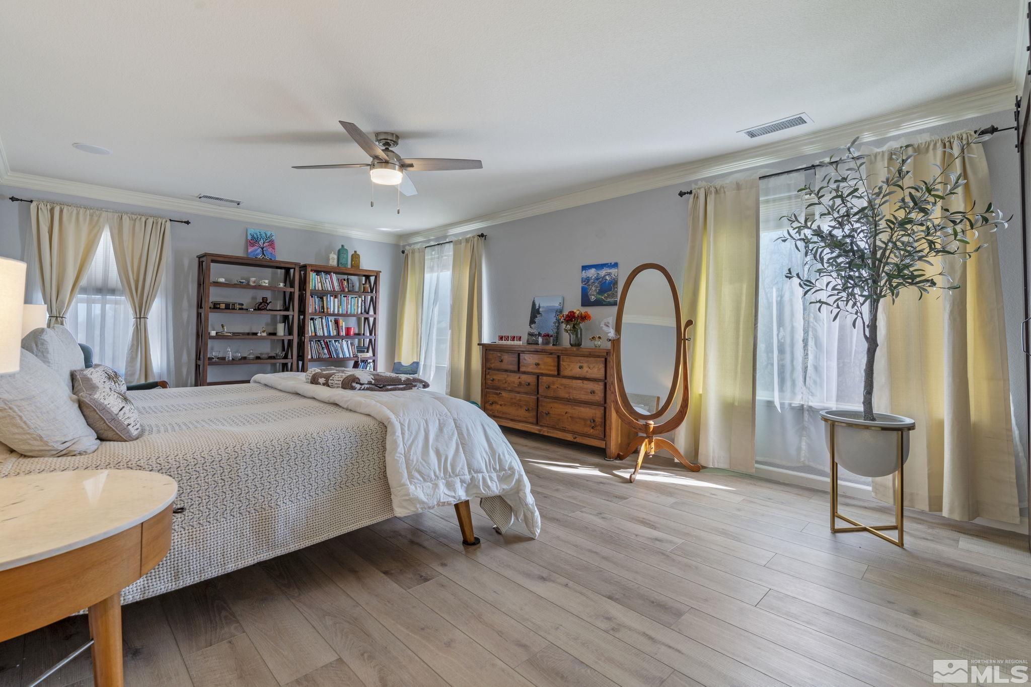 11300 Parma Court Reno, NV 89521 - Photo 25 of 40 a bed room with a bed and a chandelier