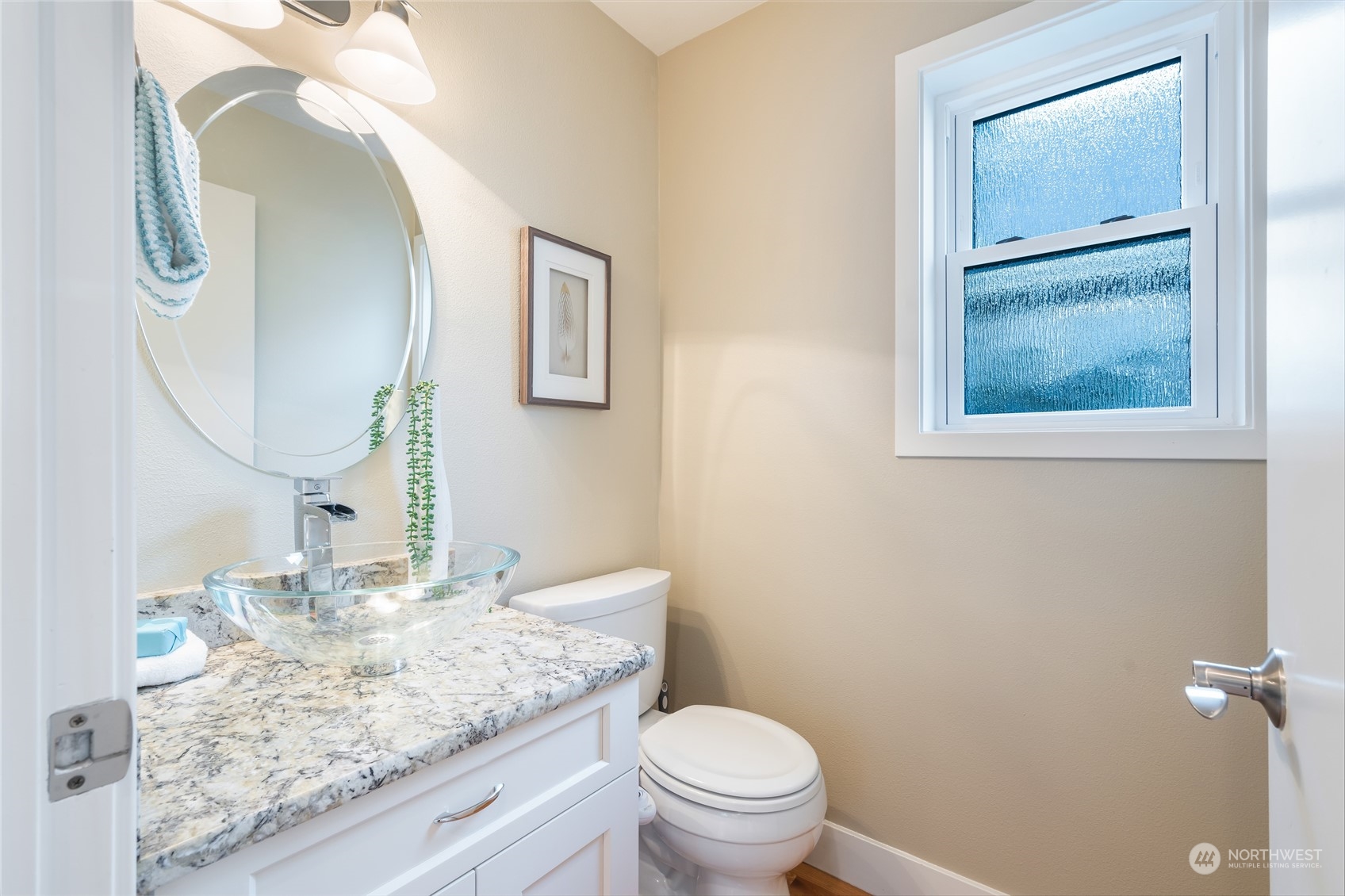 1624 38th Avenue East Seattle, WA 98112 - Photo 20 of 39 a bathroom with a granite countertop toilet a sink and mirror