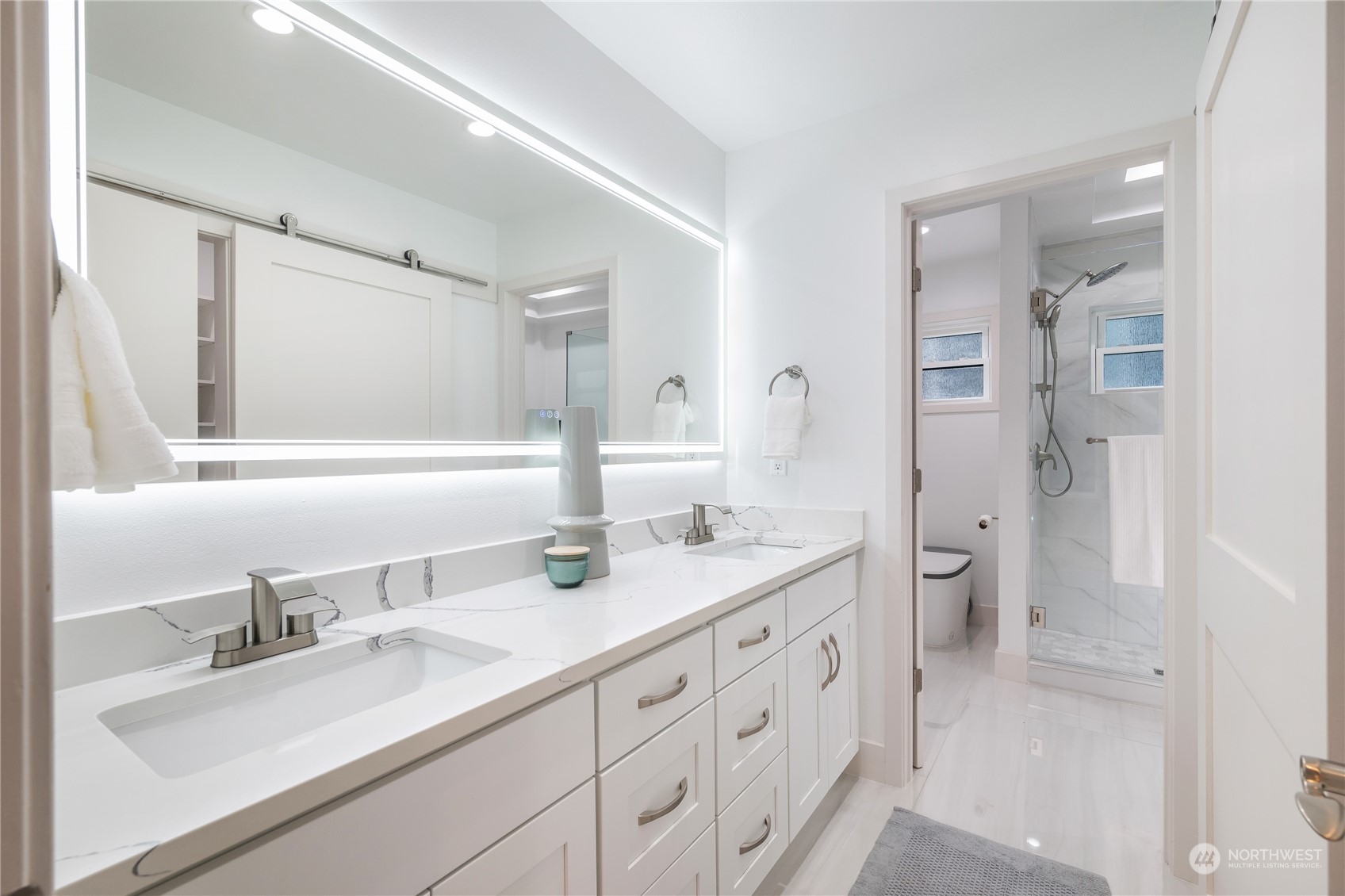 1624 38th Avenue East Seattle, WA 98112 - Photo 24 of 39 a bathroom with a double vanity sink mirror double and shower