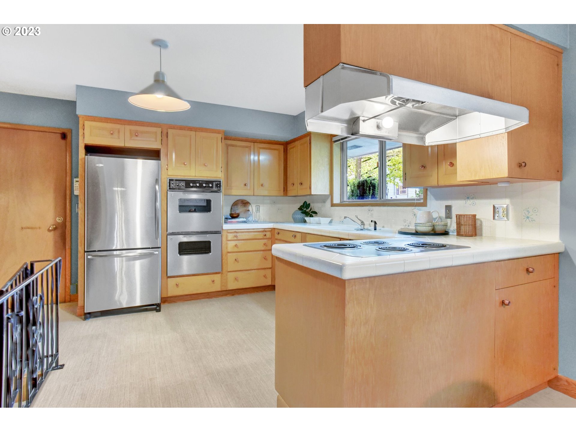 6309 Northeast Hancock Street Portland, OR 97213 - Photo 12 of 43 a kitchen with stainless steel appliances a stove a refrigerator and a sink