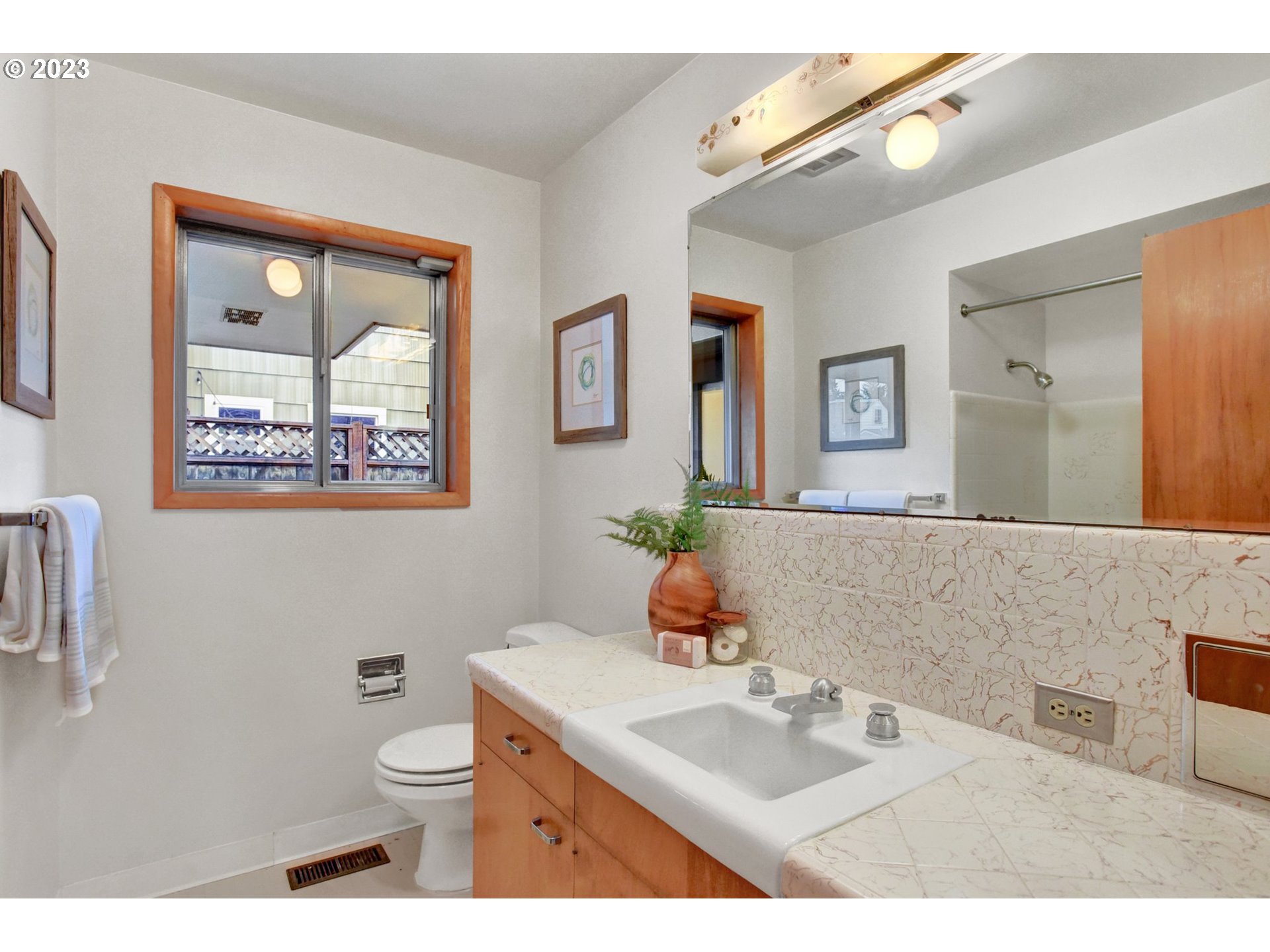 6309 Northeast Hancock Street Portland, OR 97213 - Photo 16 of 43 a bathroom with a sink mirror vanity and toilet
