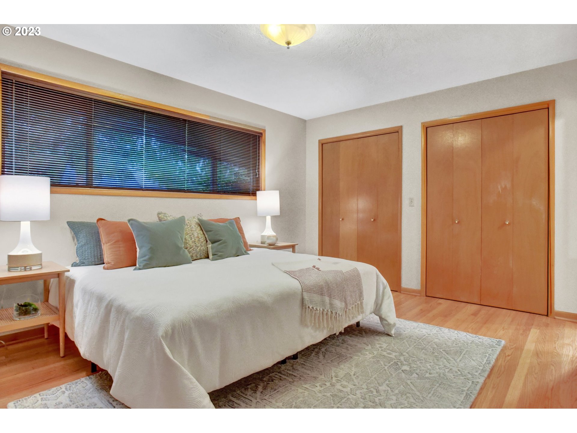 6309 Northeast Hancock Street Portland, OR 97213 - Photo 17 of 43 a bedroom with a bed and wooden floor