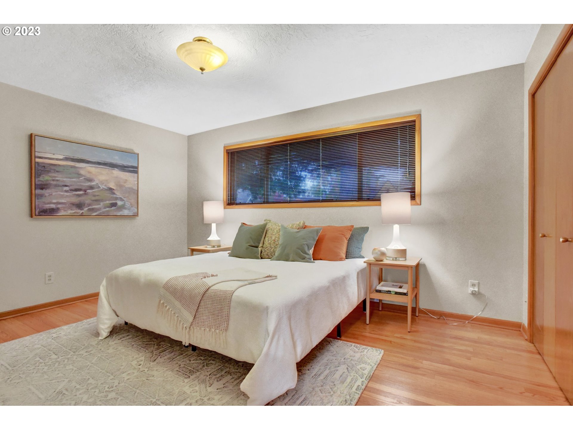 6309 Northeast Hancock Street Portland, OR 97213 - Photo 18 of 43 a bedroom with a bed and a table