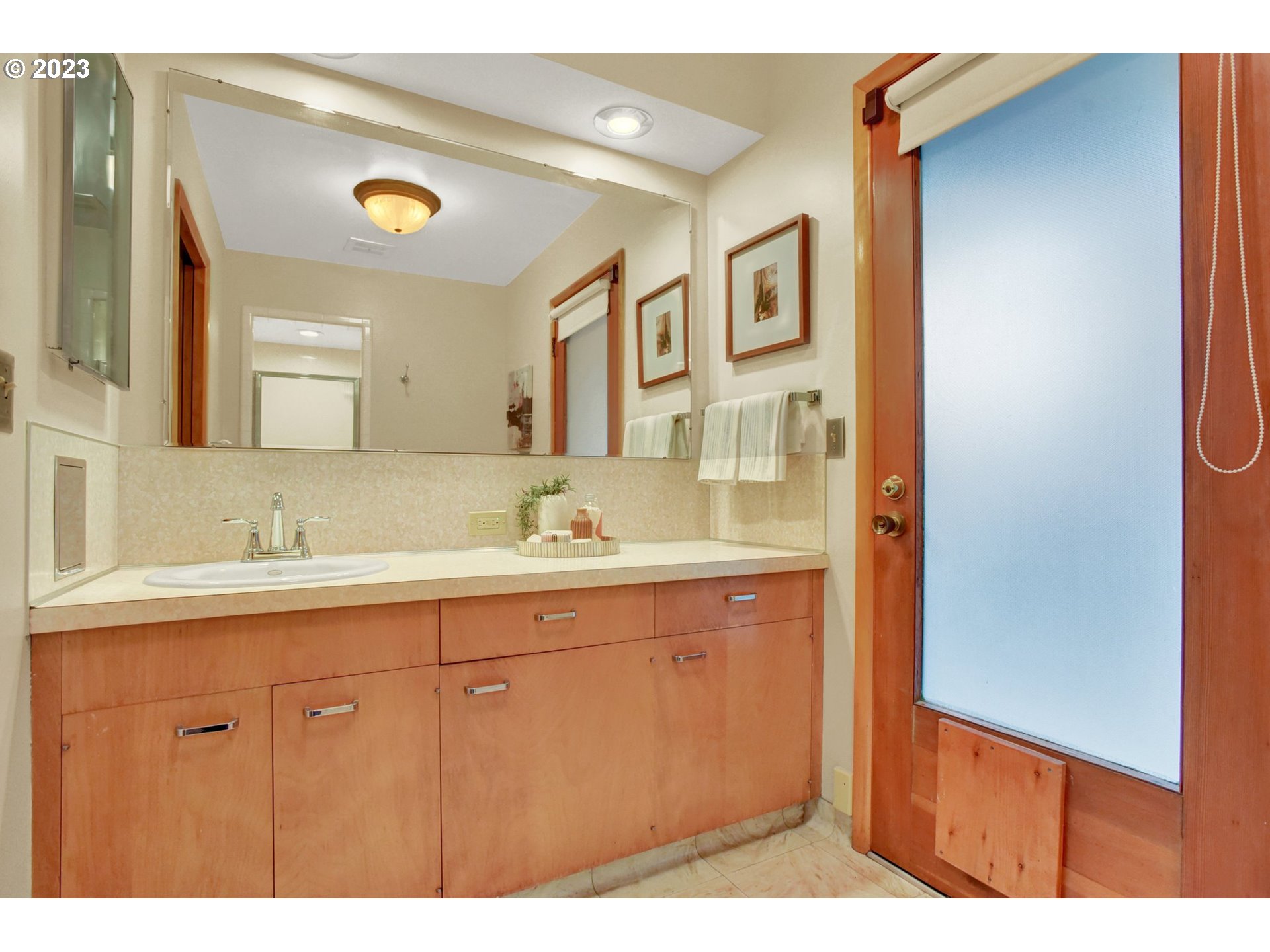 6309 Northeast Hancock Street Portland, OR 97213 - Photo 20 of 43 a bathroom with a sink a mirror and a