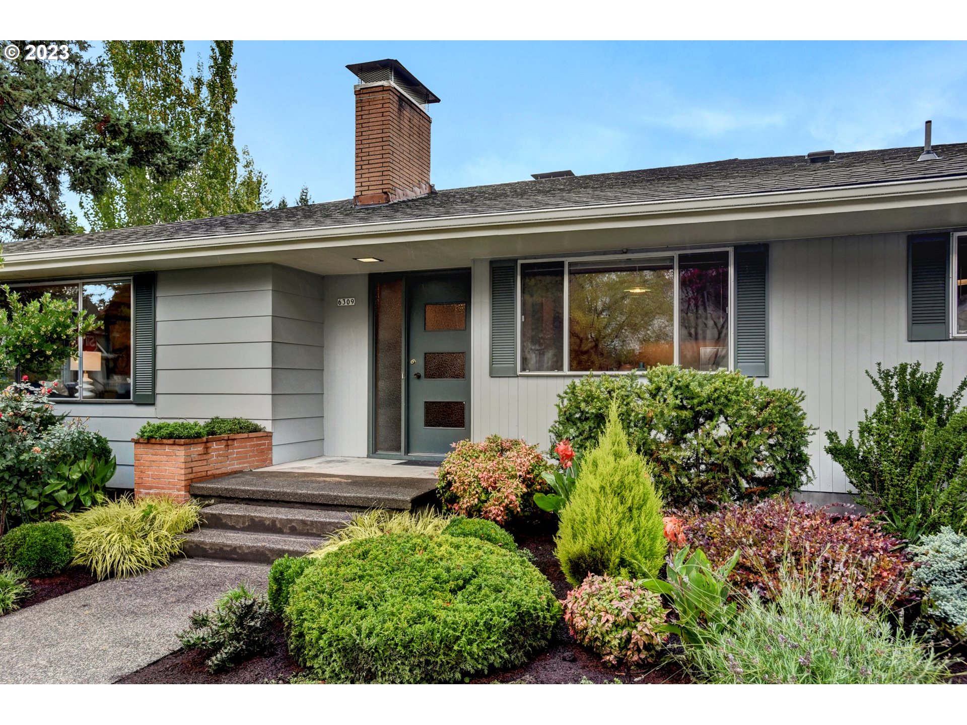 6309 Northeast Hancock Street Portland, OR 97213 - Photo 2 of 43 a view of a house with potted plants and a bench