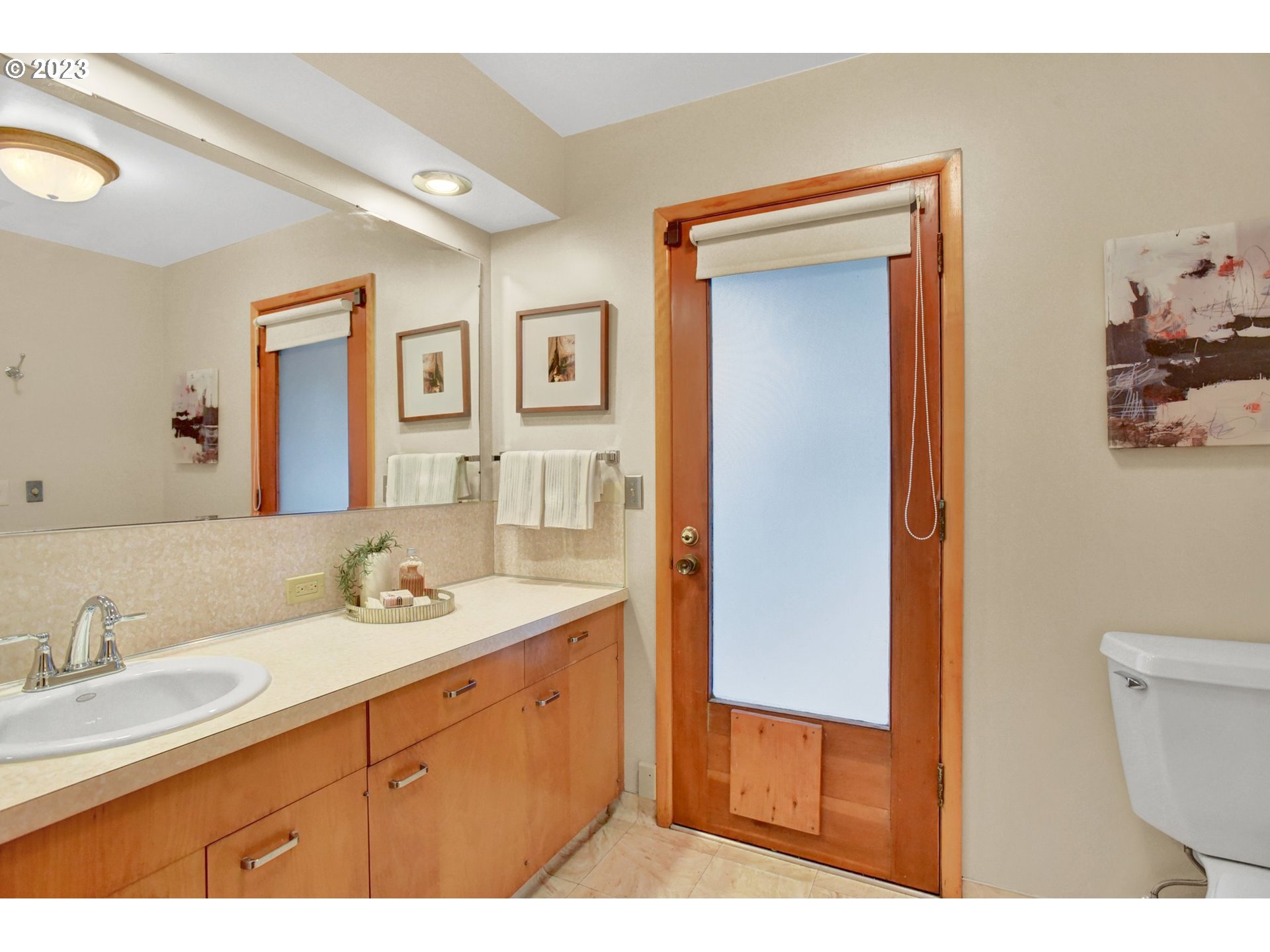 6309 Northeast Hancock Street Portland, OR 97213 - Photo 21 of 43 a bathroom with a sink a toilet and mirror