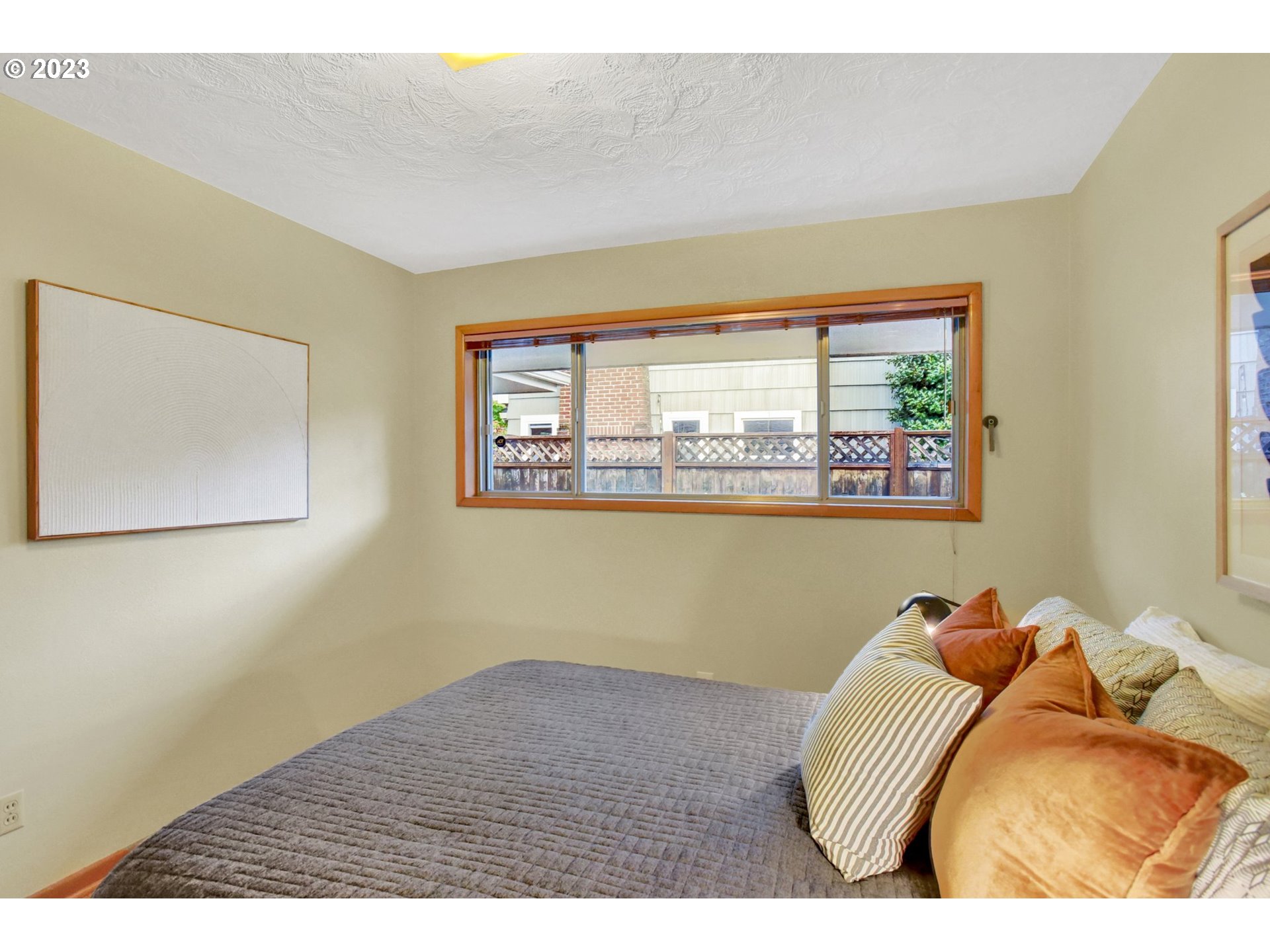 6309 Northeast Hancock Street Portland, OR 97213 - Photo 23 of 43 a bed sitting in a bedroom next to a window