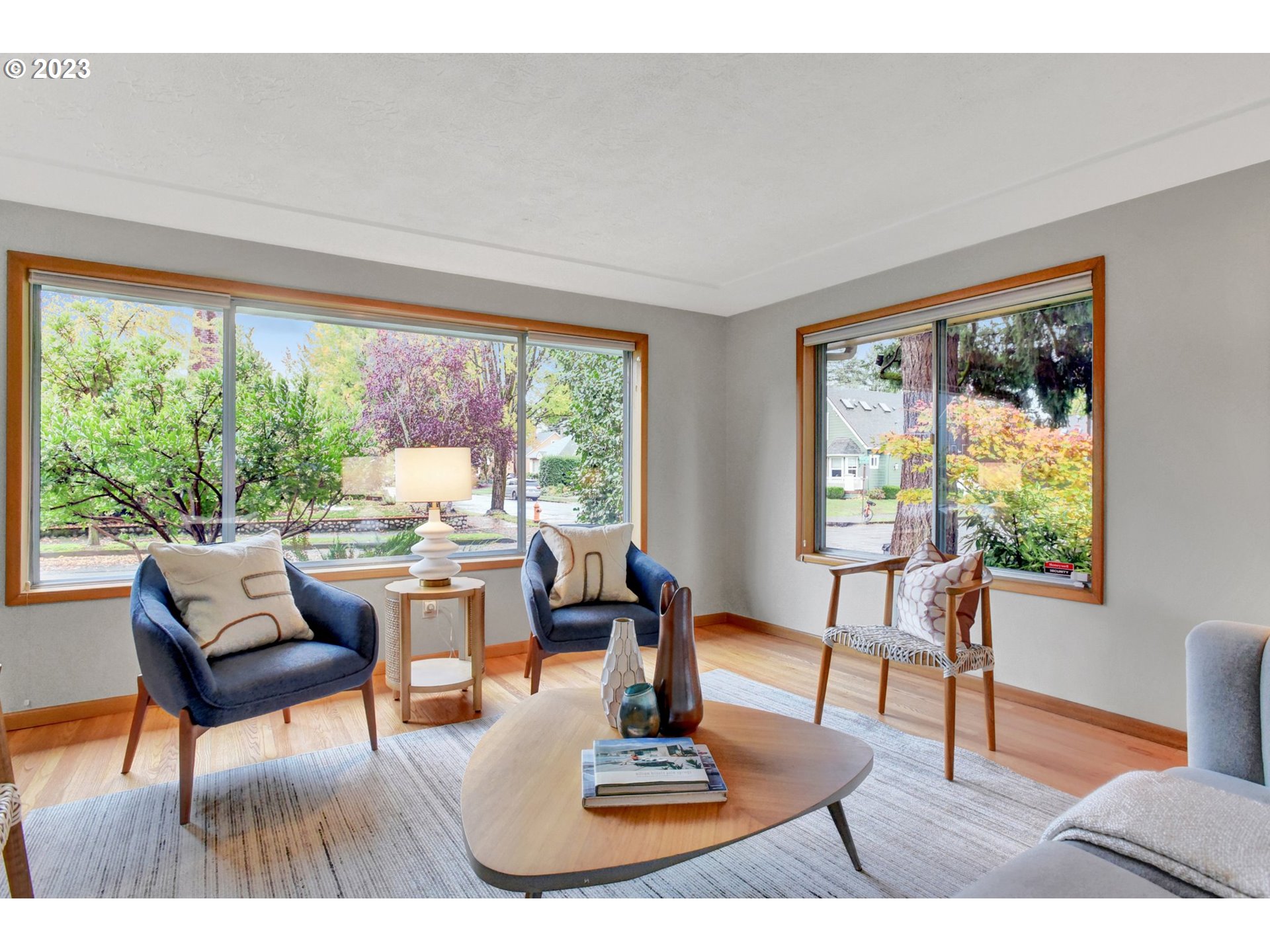6309 Northeast Hancock Street Portland, OR 97213 - Photo 6 of 43 a living room with furniture and a floor to ceiling window