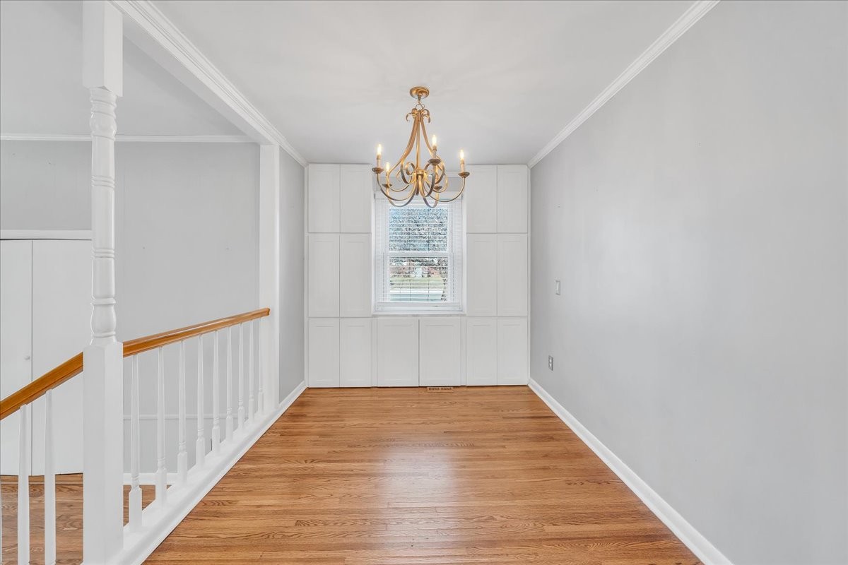 361 Tusculum Road Nashville, TN 37211 - Photo 13 of 42 a hallway with wooden floor chandelier and entryway
