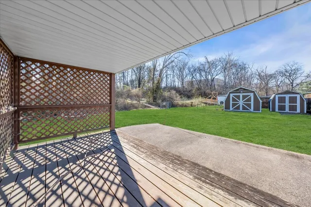 a view of a backyard with wooden fence