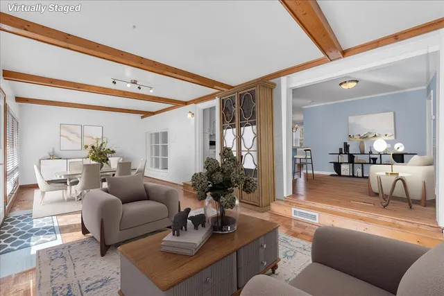 a living room with furniture and a large mirror