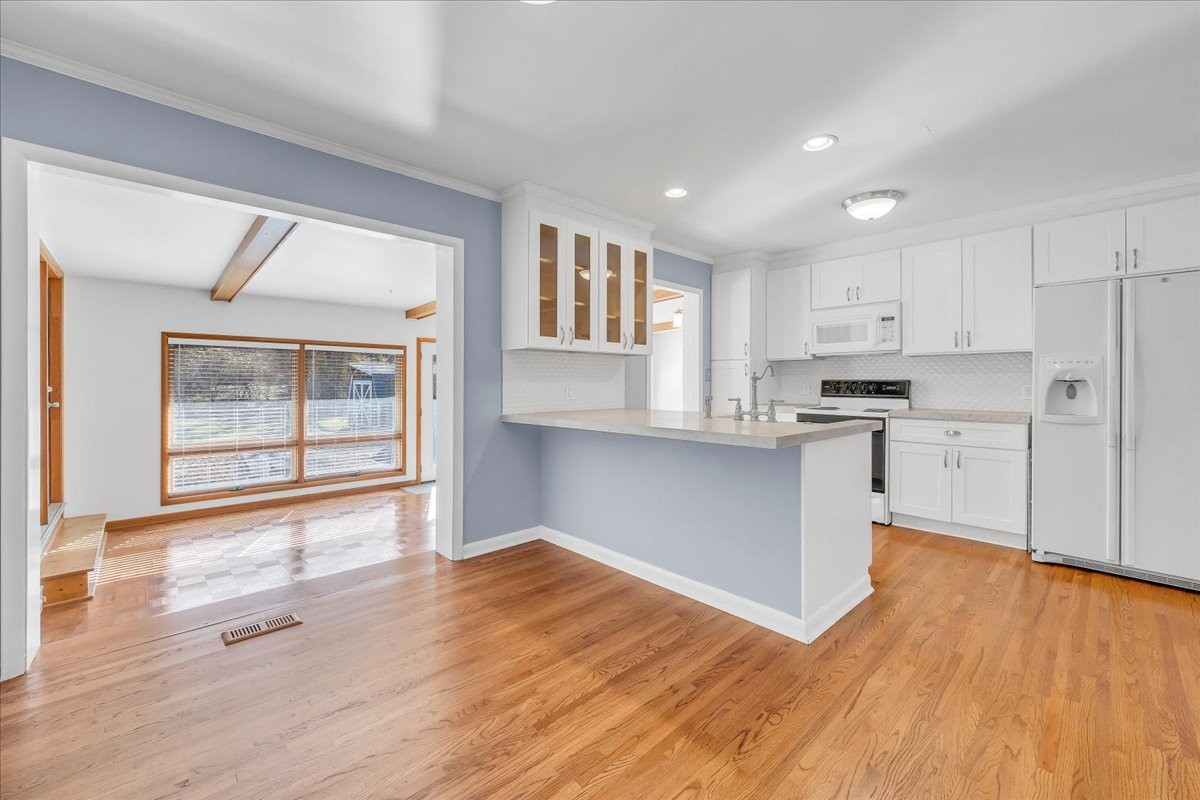 361 Tusculum Road Nashville, TN 37211 - Photo 8 of 42 a kitchen with wooden floors and white cabinets