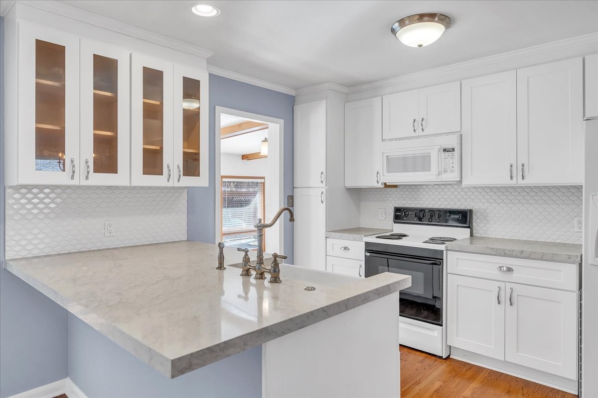 361 Tusculum Road Nashville, TN 37211 - Photo 9 of 42 a kitchen with stainless steel appliances granite countertop a sink stove and cabinets