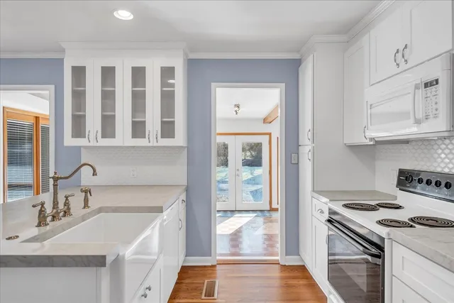 a kitchen with stainless steel appliances granite countertop a sink and a stove top oven