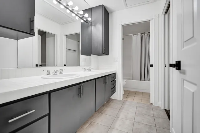 a bathroom with a double vanity sink a and mirror