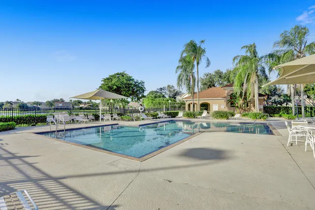 a view of a swimming pool and lounge chairs