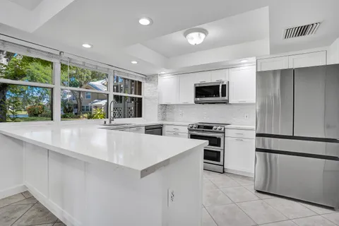 a kitchen with stainless steel appliances granite countertop a stove and a refrigerator