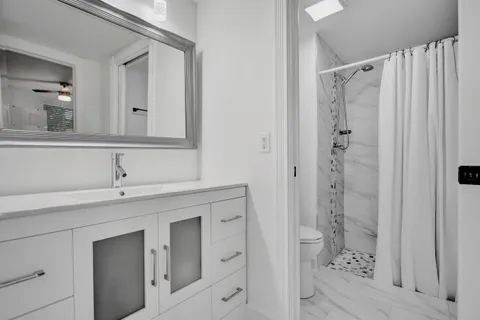 a bathroom with a shower and a sink