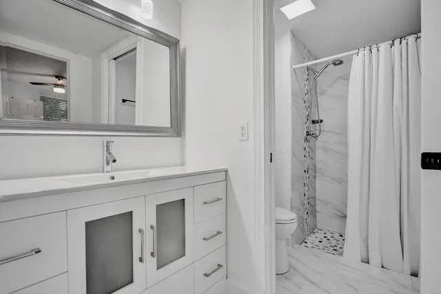 a bathroom with a shower and a sink