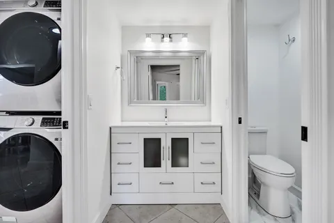 a bathroom with a toilet sink and vanity