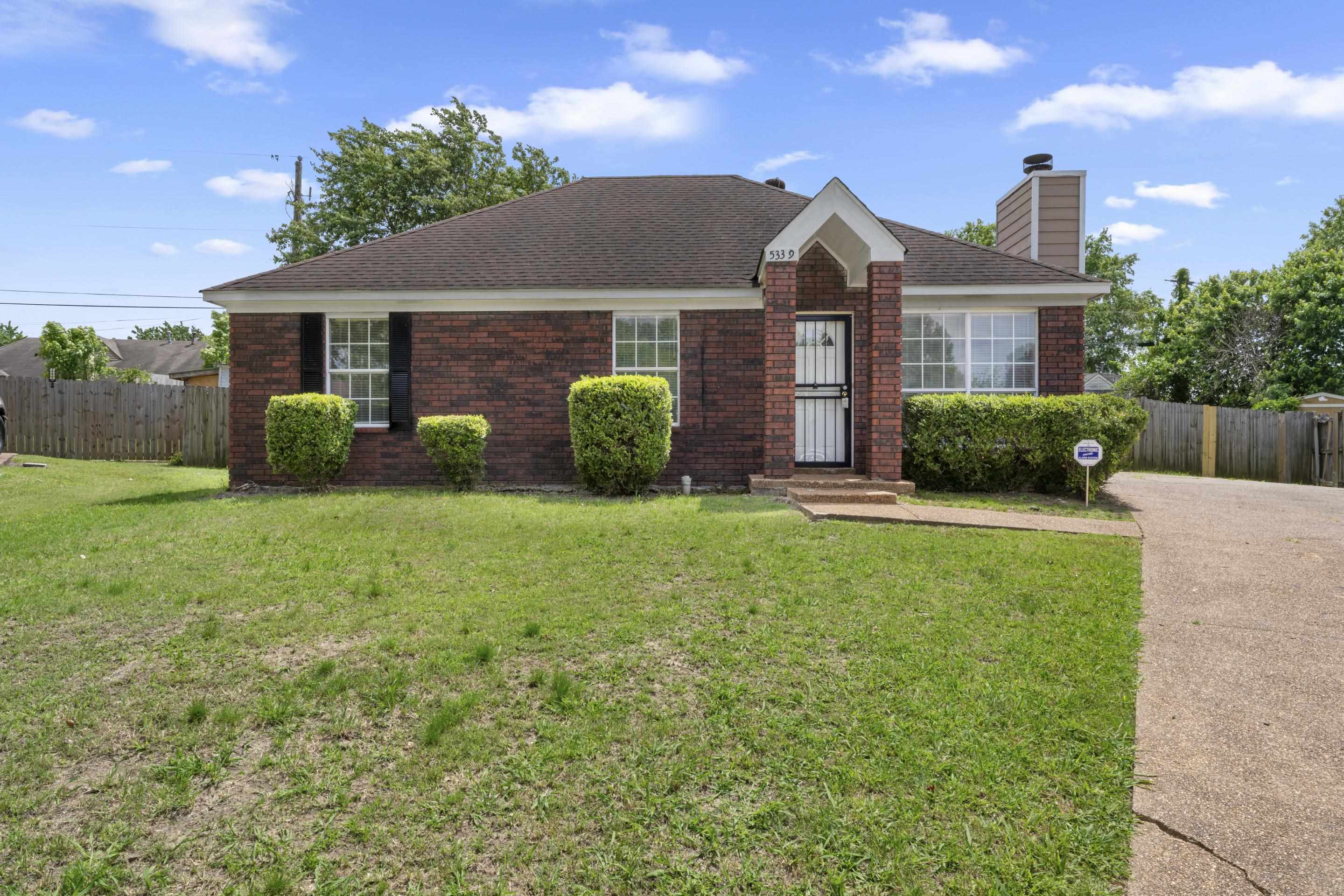 This adorable brick home offers timeless curb appeal with a spacious front yard, mature landscaping, and a welcoming covered entry that makes you feel right at home.