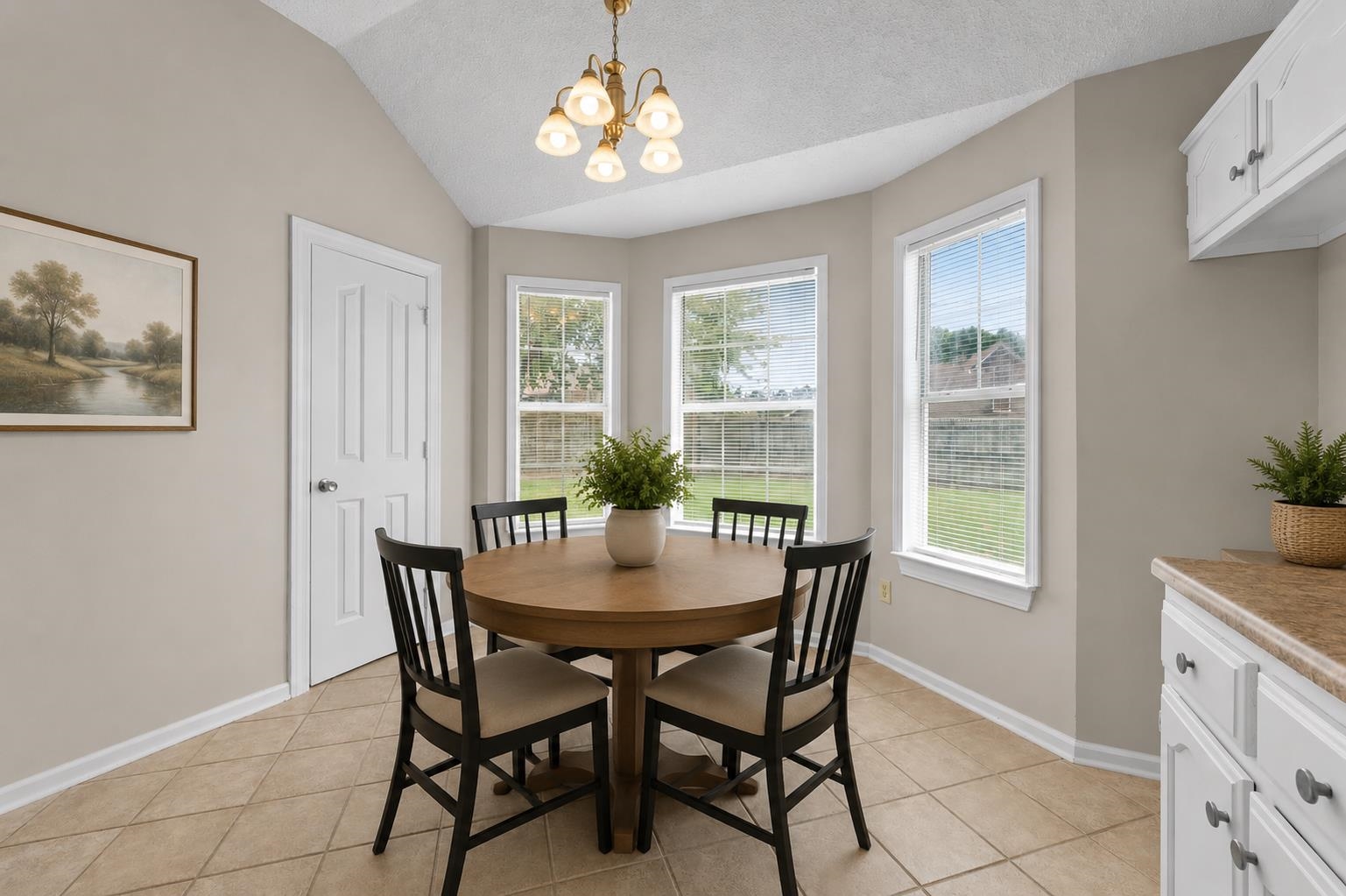 5339 Shady Ridge Cove Memphis, TN 38141 - Photo 12 of 31 The charming breakfast area features vaulted ceilings and multiple windows that bring in beautiful natural light while offering peaceful views of the fenced backyard.