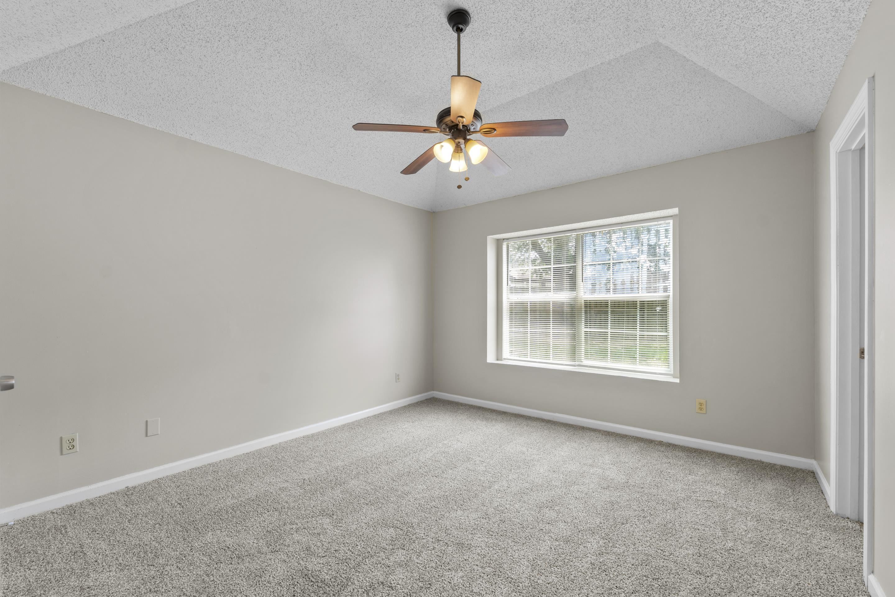 5339 Shady Ridge Cove Memphis, TN 38141 - Photo 15 of 31 This inviting primary bedroom features new carpet, natural light, and a comfortable layout with a vaulted ceiling that adds an airy and open feel.