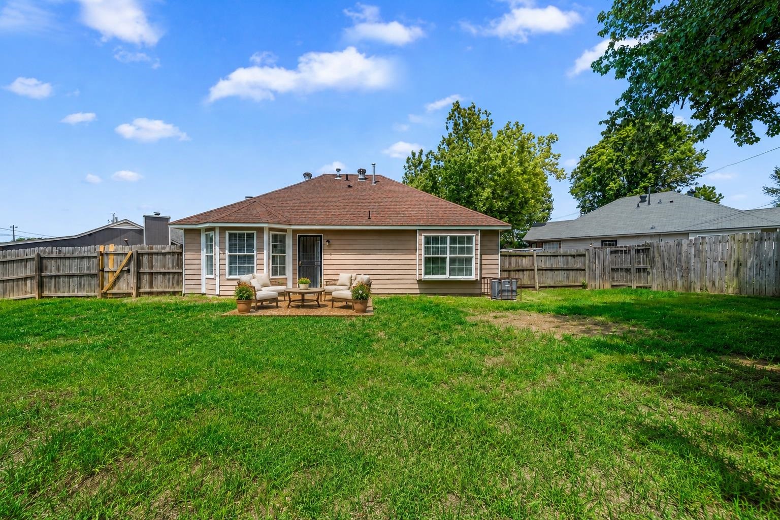 5339 Shady Ridge Cove Memphis, TN 38141 - Photo 26 of 31 Virtually staged to showcase the possibilities, this patio and backyard space offers a wonderful setting for outdoor entertaining, relaxing, and enjoying the spacious fenced yard.