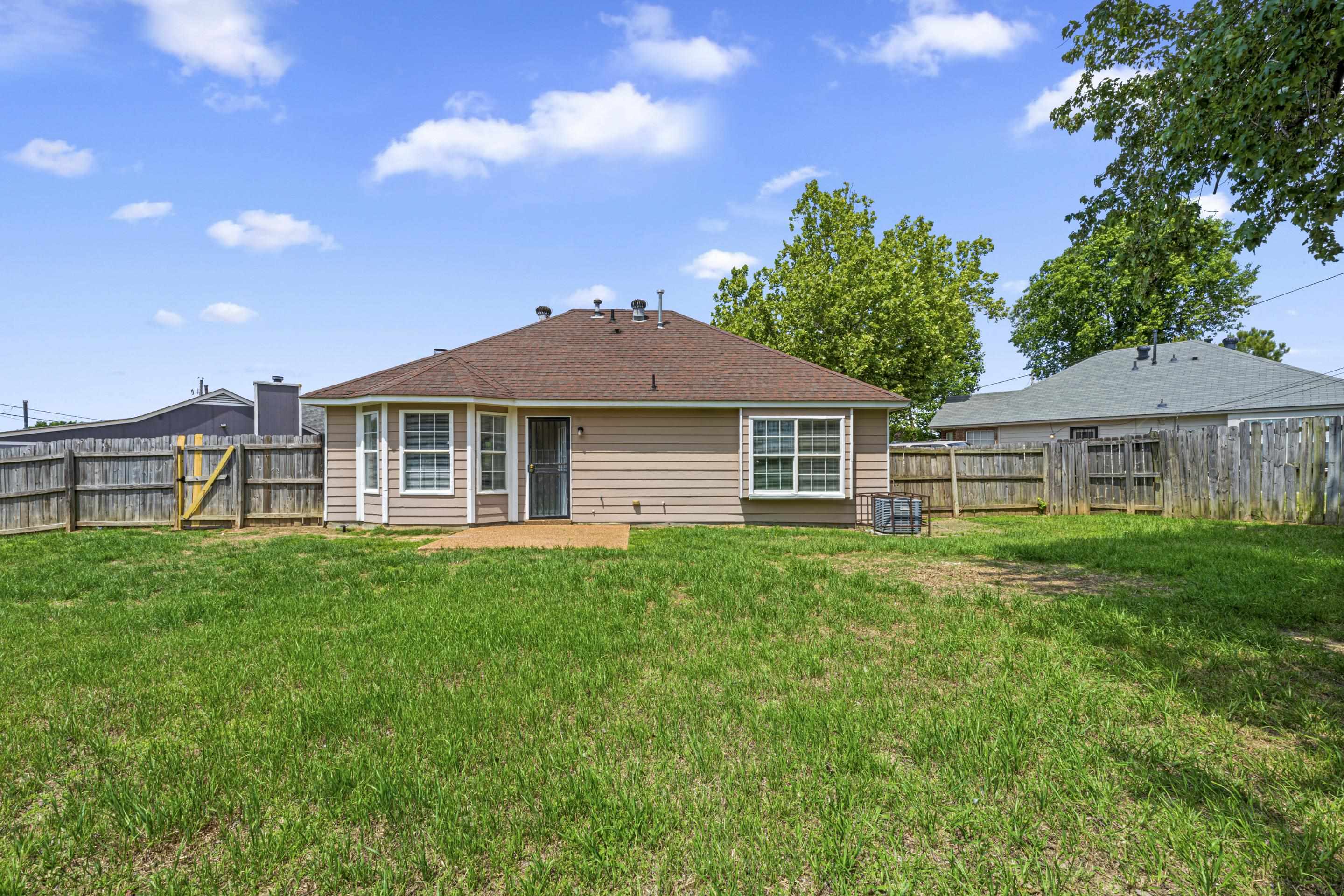 5339 Shady Ridge Cove Memphis, TN 38141 - Photo 27 of 31 Enjoy outdoor living in the large backyard featuring a patio area perfect for grilling, relaxing, or gathering.