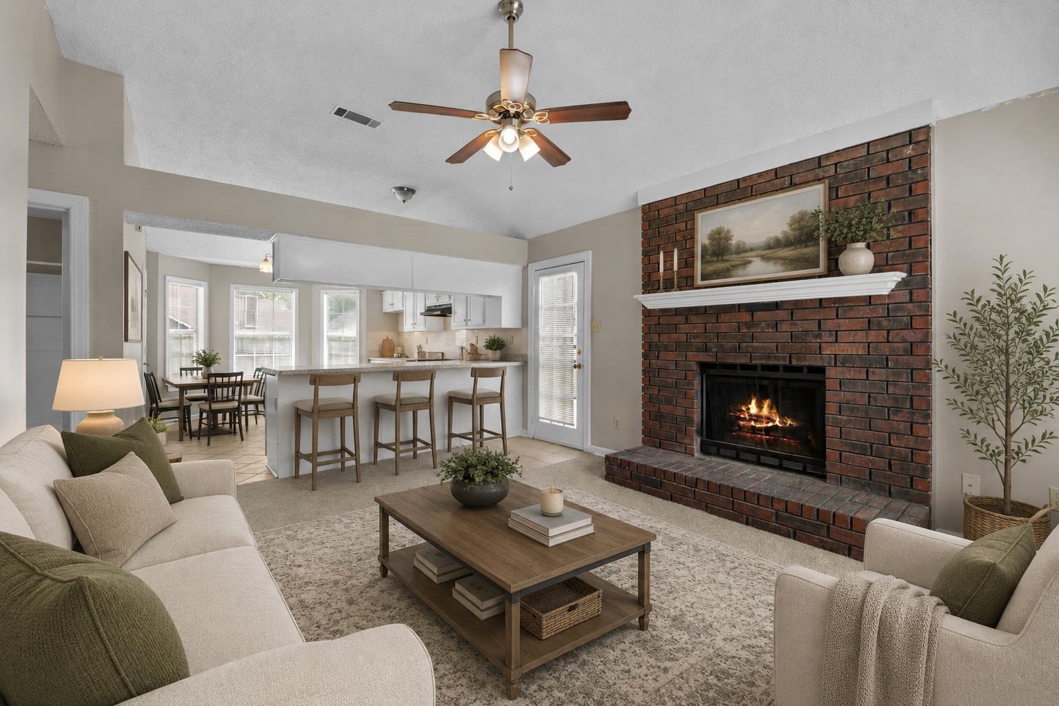 5339 Shady Ridge Cove Memphis, TN 38141 - Photo 4 of 31 The inviting great room features soaring ceilings, a beautiful brick fireplace, ceiling fan, and an open flow into the kitchen and breakfast area. The layout is perfect for relaxing nights at home or entertaining family and friends.
