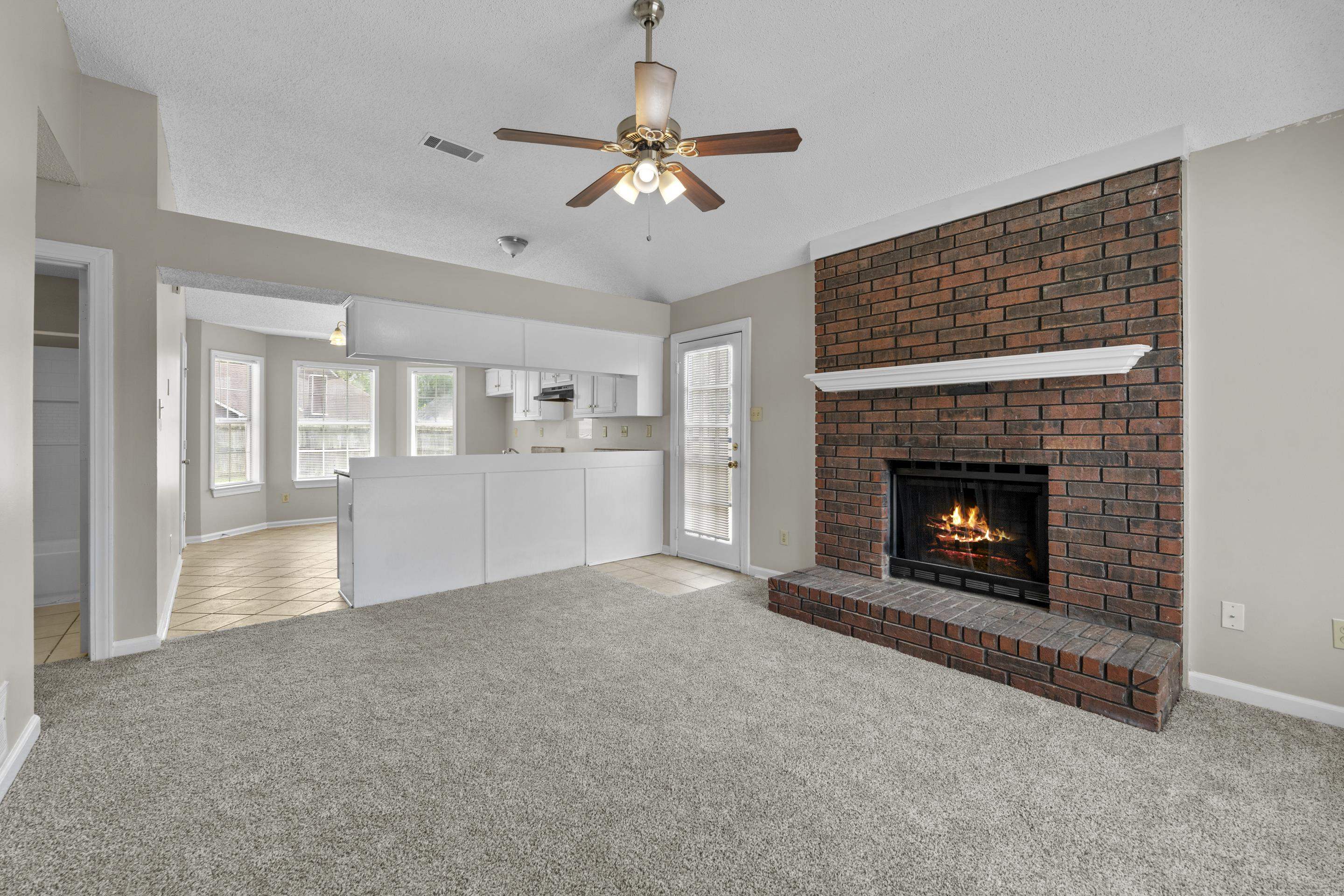 5339 Shady Ridge Cove Memphis, TN 38141 - Photo 5 of 31 This warm and welcoming great room offers new carpet, a dramatic brick fireplace, and an open design that connects seamlessly to the kitchen and dining spaces for easy everyday living.