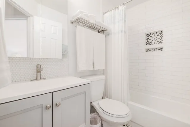 a bathroom with a sink toilet vanity and shower