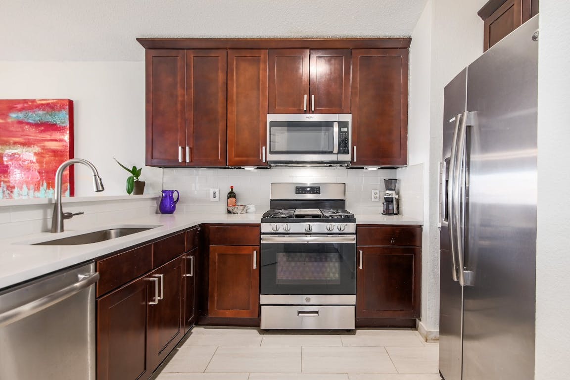 16806 Langland Road Pflugerville, TX 78660 - Photo 18 of 31 a kitchen with a sink stove and refrigerator