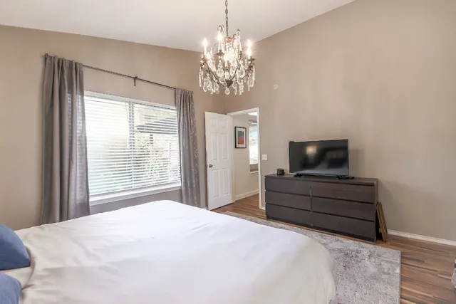 a bedroom with a bed and a flat screen tv