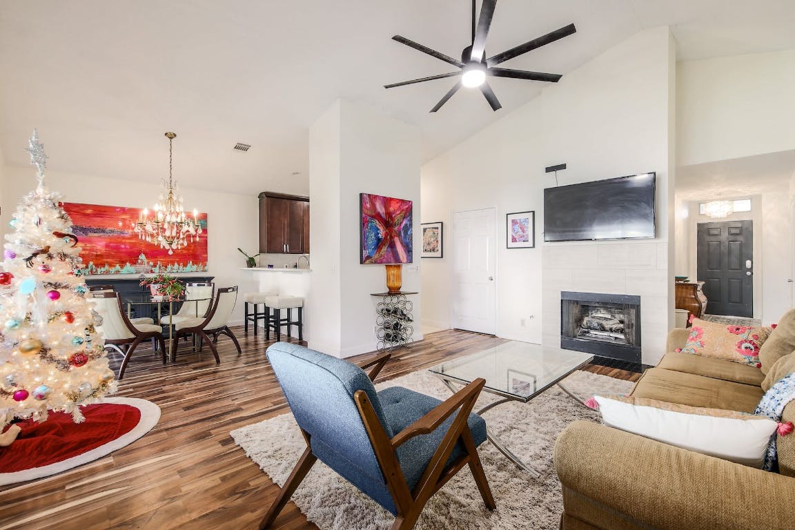 16806 Langland Road Pflugerville, TX 78660 - Photo 2 of 31 a living room with furniture a flat screen tv and a fireplace