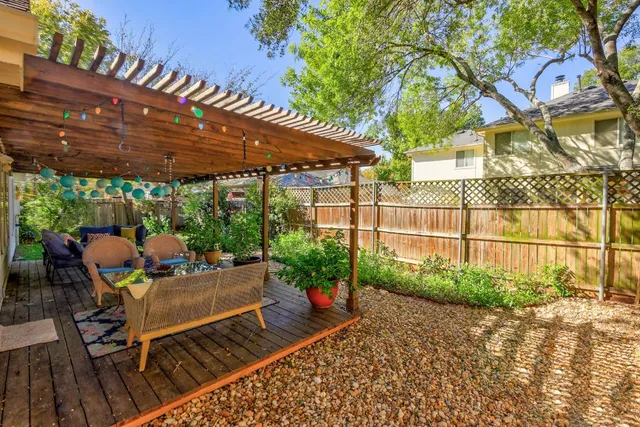 a view of a patio with table and chairs potted plants with wooden floor