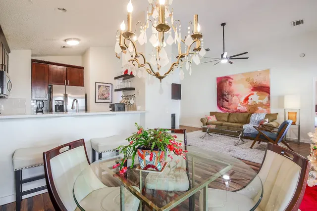 a view of a dining room with furniture wooden floor and a chandelier