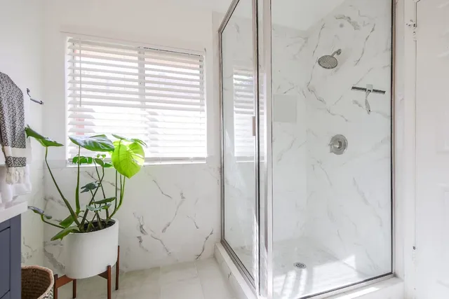 a white vase with flowers sitting on a table