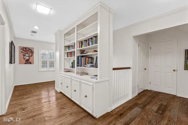 a room with a bed and a book shelf