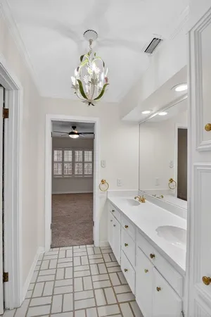 a spacious bathroom with a sink a large mirror and a shower