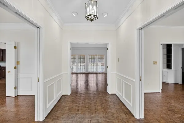 a view of a hallway with windows and stairs