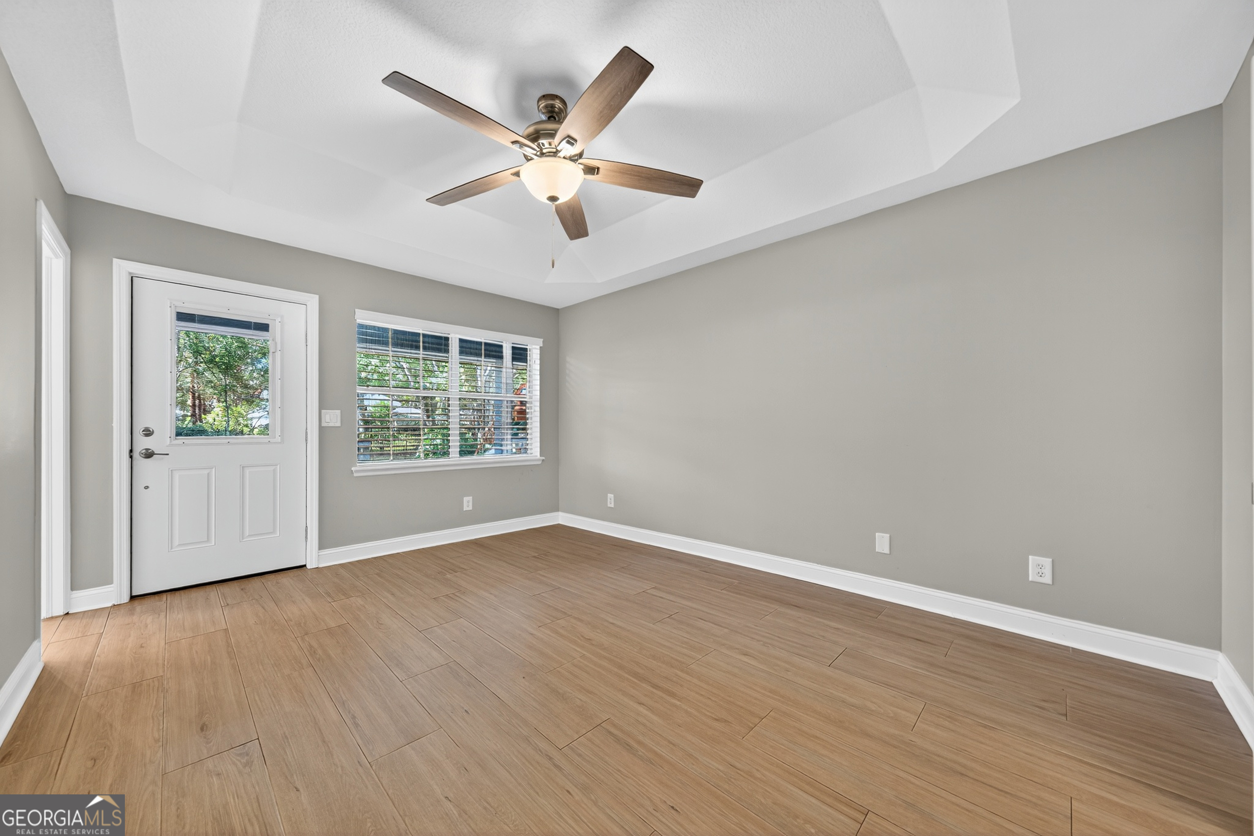 404 Morning Glory Road St. Marys, GA 31558 - Photo 19 of 34 a view of an empty room with wooden floor and a window