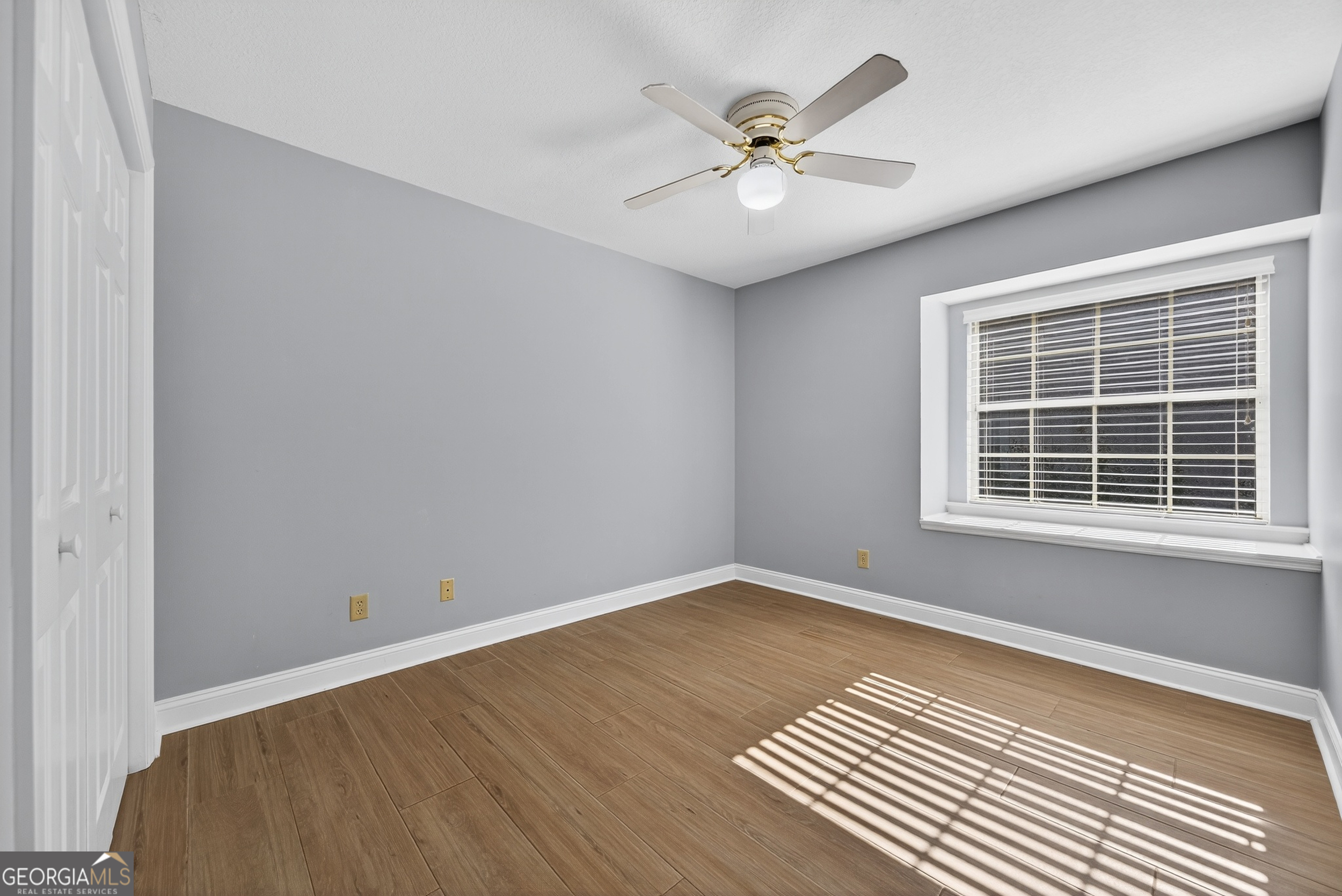 404 Morning Glory Road St. Marys, GA 31558 - Photo 25 of 34 a view of an empty room with a window and wooden floor